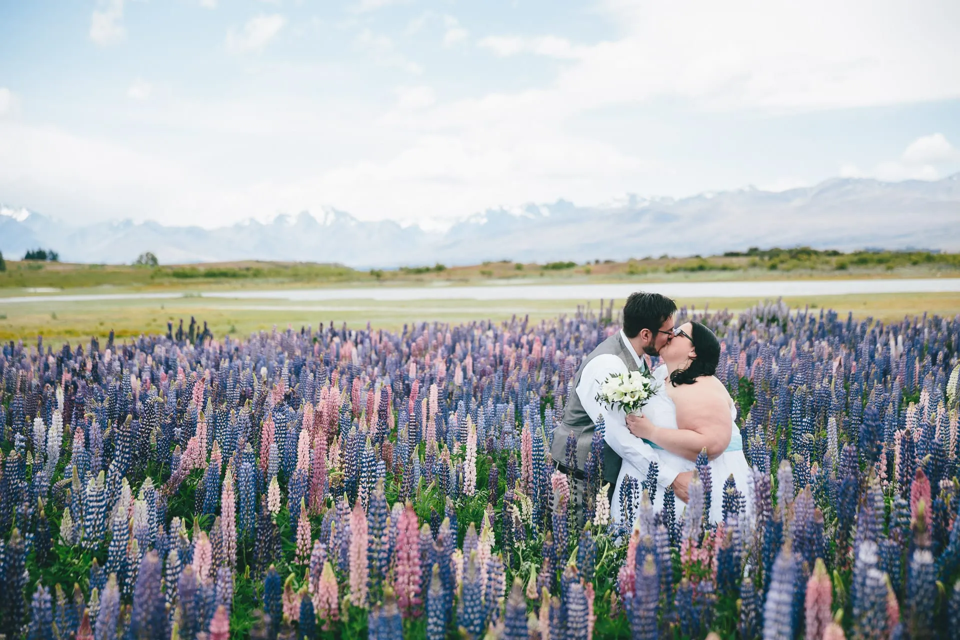 A wedding among the summer lupins at Lake Tekapo